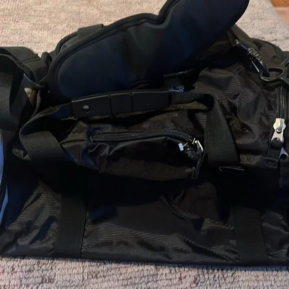 New OGIO sports illustrated black and gray duffle bag with shoulder strap.